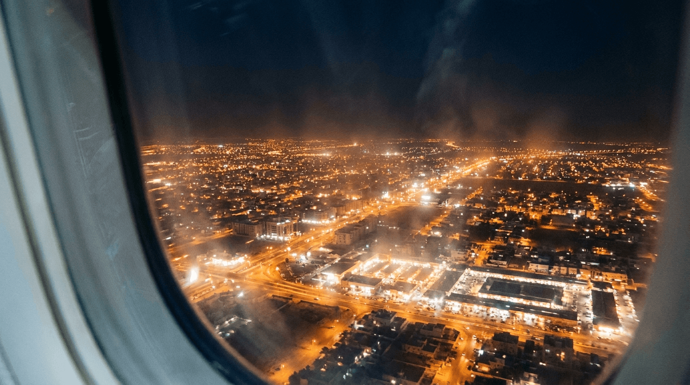 A city skyline seen from the air at night.