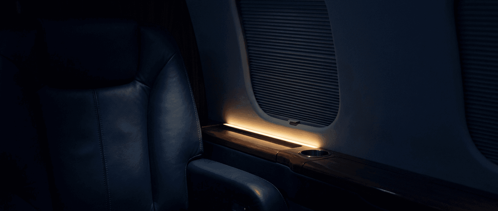 An empty private jet cabin at night.